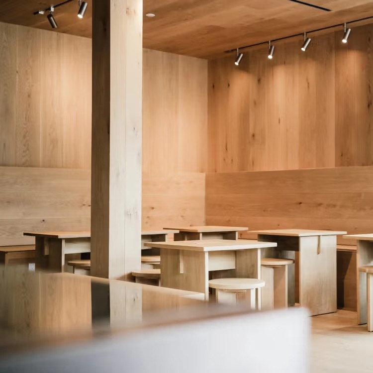 The light wood dining room at Stereoscope Coffee with handmade tables and stools
